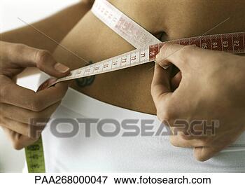 Picture - woman measuring 
waist, close-up. 
fotosearch - search 
stock photos, 
pictures, images, 
and photo clipart