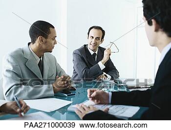Stock Photograph - business people 
sitting around 
table having meeting. 
fotosearch - search 
stock photos, 
pictures, images, 
and photo clipart