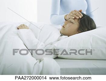 Stock Photo - girl lying in 
bed under covers, 
woman's hand on 
girl's forehead. 
fotosearch - search 
stock photos, 
pictures, images, 
and photo clipart