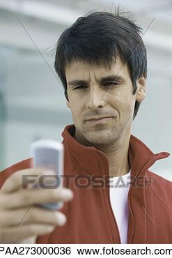 Stock Photo - man looking at 
cell phone. fotosearch 
- search stock 
photos, pictures, 
images, and photo 
clipart