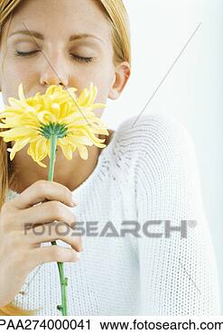 Stock Photography - woman smelling 
flower with eyes 
closed. fotosearch 
- search stock 
photos, pictures, 
images, and photo 
clipart