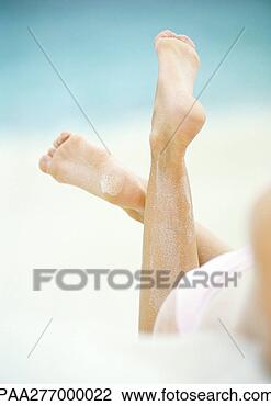 Stock Photo - woman lying in 
sand, close-up 
of lower legs. 
fotosearch - search 
stock photos, 
pictures, images, 
and photo clipart