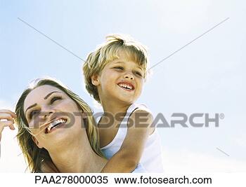 Stock Image - boy and mother, 
boy behind mother 
with arms around 
her neck, portrait. 
fotosearch - search 
stock photos, 
pictures, images, 
and photo clipart