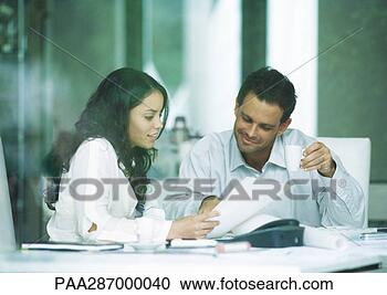 Stock Photography - young adults examining 
documents. fotosearch 
- search stock 
photos, pictures, 
images, and photo 
clipart