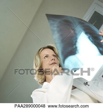 Stock Photo - female doctor 
in x-ray lab. 
fotosearch - search 
stock photos, 
pictures, images, 
and photo clipart