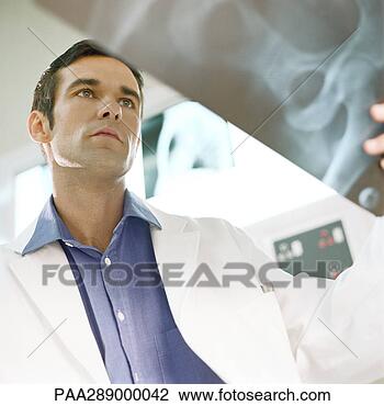 Stock Photo - male doctor in 
x-ray lab. fotosearch 
- search stock 
photos, pictures, 
images, and photo 
clipart