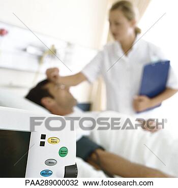 Stock Photo - nurse checking 
on patient. fotosearch 
- search stock 
photos, pictures, 
images, and photo 
clipart