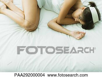 Stock Photo - young woman lying 
on bed with eyes 
open. fotosearch 
- search stock 
photos, pictures, 
images, and photo 
clipart