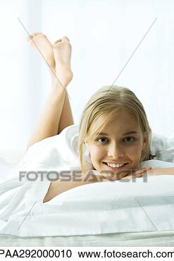 Stock Photography - young woman lying 
on stomach with 
legs up. fotosearch 
- search stock 
photos, pictures, 
images, and photo 
clipart