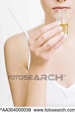 Stock Photo - woman smelling 
bottle of essential 
oil. fotosearch 
- search stock 
photos, pictures, 
images, and photo 
clipart