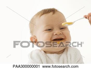 Stock Photography - smiling baby being 
fed baby food. 
fotosearch - search 
stock photos, 
pictures, images, 
and photo clipart