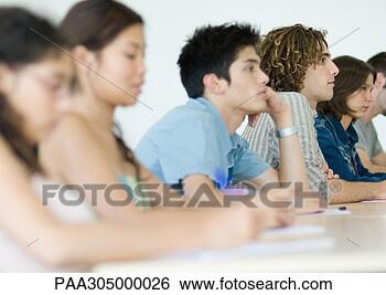 Stock Photo - students sitting 
side by side attentively 
in class. fotosearch 
- search stock 
photos, pictures, 
images, and photo 
clipart