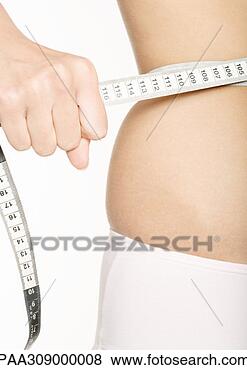 Stock Photo - woman squeezing 
measuring tape 
around waist. 
fotosearch - search 
stock photos, 
pictures, images, 
and photo clipart