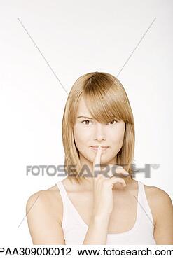 Stock Photo - young woman with 
finger in front 
of lips. fotosearch 
- search stock 
photos, pictures, 
images, and photo 
clipart