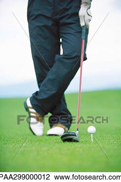 Stock Photo - golfer standing 
next to teed golf 
ball, low section. 
fotosearch - search 
stock photos, 
pictures, images, 
and photo clipart