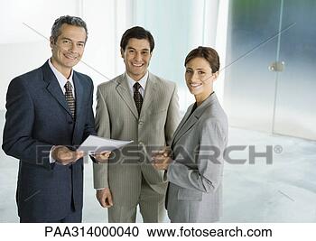 Stock Photography - three business 
associates standing 
in lobby, smiling. 
fotosearch - search 
stock photos, 
pictures, images, 
and photo clipart