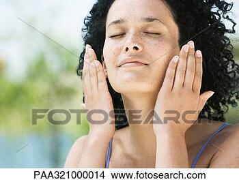 Stock Photo - young woman with 
eyes closed and 
hands near face. 
fotosearch - search 
stock photos, 
pictures, images, 
and photo clipart