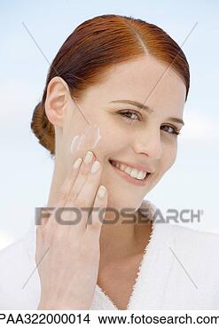 Stock Photo - woman applying 
moisturizer and 
wearing bathrobe. 
fotosearch - search 
stock photos, 
pictures, images, 
and photo clipart