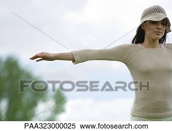 Stock Image - woman standing 
outdoors with 
arms out, cropped. 
fotosearch - search 
stock photos, 
pictures, images, 
and photo clipart