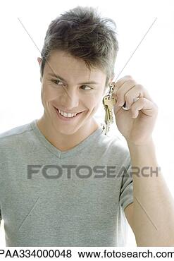 Stock Photo - man holding up 
keys. fotosearch 
- search stock 
photos, pictures, 
images, and photo 
clipart