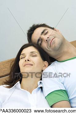 Stock Photo - couple resting 
on a bench,  reclining 
with eyes closed 
and heads. fotosearch 
- search stock 
photos, pictures, 
images, and photo 
clipart