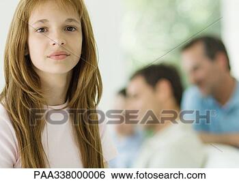 Stock Photo - preteen girl, 
family in background. 
fotosearch - search 
stock photos, 
pictures, images, 
and photo clipart