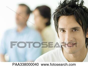 Stock Photography - young man, parents 
in background. 
fotosearch - search 
stock photos, 
pictures, images, 
and photo clipart