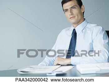 Stock Photo - businessman sitting 
at desk, portrait. 
fotosearch - search 
stock photos, 
pictures, images, 
and photo clipart