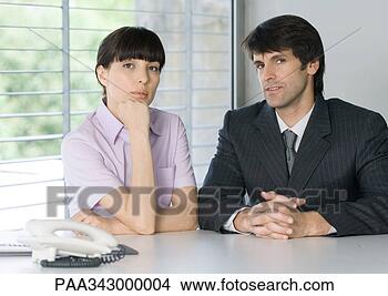 Stock Photo - two business people 
next to phone 
in office. fotosearch 
- search stock 
photos, pictures, 
images, and photo 
clipart