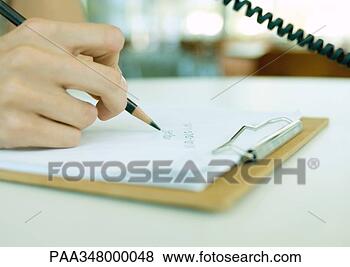 Stock Photo - person using phone, 
 writing down 
phone number on 
clipboard,  extreme. 
fotosearch - search 
stock photos, 
pictures, images, 
and photo clipart