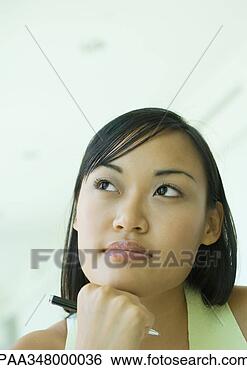 Stock Photo - woman resting 
head on hand, 
holding pen, looking 
away. fotosearch 
- search stock 
photos, pictures, 
images, and photo 
clipart