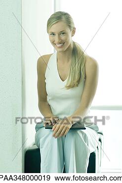 Stock Photograph - woman sitting 
with file on knees. 
fotosearch - search 
stock photos, 
pictures, images, 
and photo clipart