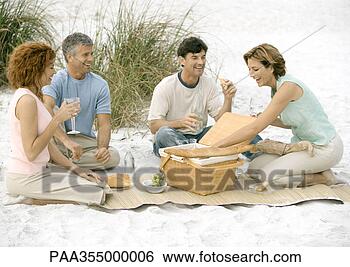 Stock Photo - two mature couples 
having picnic 
on beach. fotosearch 
- search stock 
photos, pictures, 
images, and photo 
clipart