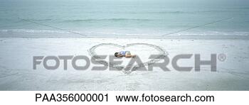 Stock Photography - child lying inside 
heart drawn on 
beach. fotosearch 
- search stock 
photos, pictures, 
images, and photo 
clipart