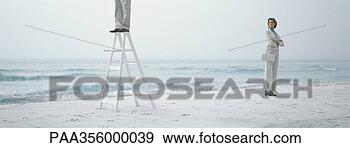 Stock Photograph - woman standing 
on beach with 
arms crossed, 
 looking toward 
man. fotosearch 
- search stock 
photos, pictures, 
images, and photo 
clipart