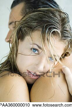 Stock Photography - woman embracing 
man, looking at 
camera. fotosearch 
- search stock 
photos, pictures, 
images, and photo 
clipart