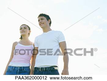 Stock Photo - young couple walking 
outdoors, front 
view. fotosearch 
- search stock 
photos, pictures, 
images, and photo 
clipart