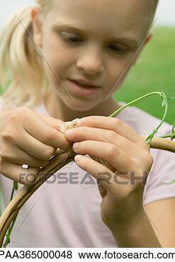 Stock Photo - girl wrapping 
vine around wooden 
pole. fotosearch 
- search stock 
photos, pictures, 
images, and photo 
clipart