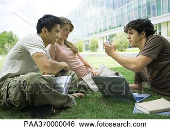 Stock Photo - group of college 
students studying 
in grass. fotosearch 
- search stock 
photos, pictures, 
images, and photo 
clipart