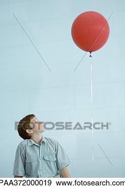 Stock Photograph - boy looking up 
at balloon. fotosearch 
- search stock 
photos, pictures, 
images, and photo 
clipart
