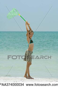 Stock Photo - girl on beach, 
holding up fishing 
net overhead. 
fotosearch - search 
stock photos, 
pictures, images, 
and photo clipart