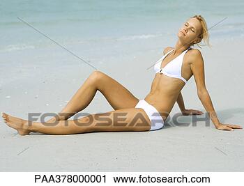 Stock Photography - woman lounging 
on beach in sun, 
full length. fotosearch 
- search stock 
photos, pictures, 
images, and photo 
clipart