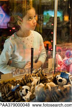 Stock Photo - girl looking through 
glass of toy grabbing 
game. fotosearch 
- search stock 
photos, pictures, 
images, and photo 
clipart