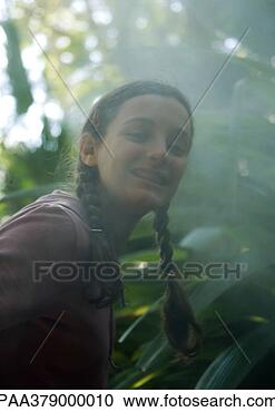 Stock Photography - teen girl smiling 
in mist. fotosearch 
- search stock 
photos, pictures, 
images, and photo 
clipart