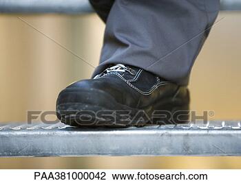 Stock Photo - man wearing safety 
shoes, close-up 
of shoe. fotosearch 
- search stock 
photos, pictures, 
images, and photo 
clipart