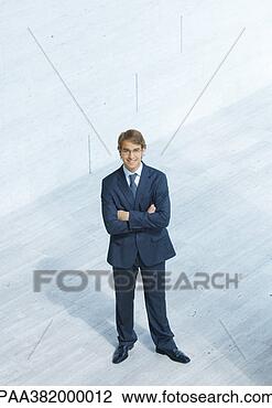 Stock Photo - businessman standing 
with arms folded, 
high angle view. 
fotosearch - search 
stock photos, 
pictures, images, 
and photo clipart