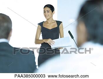 Stock Photo - executive woman 
standing next 
to microphone 
during seminar. 
fotosearch - search 
stock photos, 
pictures, images, 
and photo clipart