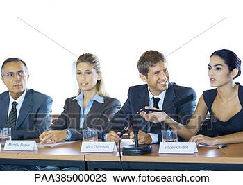 Stock Photo - executives sitting 
at conference 
table, one woman 
speaking. fotosearch 
- search stock 
photos, pictures, 
images, and photo 
clipart