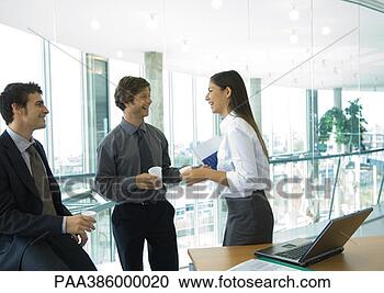 Stock Photography - three office workers 
standing with 
cups of coffee, 
talking. fotosearch 
- search stock 
photos, pictures, 
images, and photo 
clipart