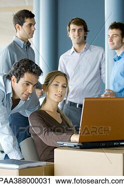 Stock Photography - business people 
using laptop on 
cardboard box. 
fotosearch - search 
stock photos, 
pictures, images, 
and photo clipart